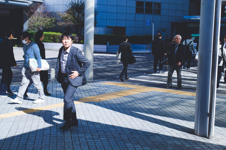 OSAKA, JAPAN-NOV 8, 2019: Japanese businessmen wait by crossroadのeditorial素材