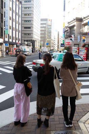 OSAKA, JAPAN-NOV 8, 2019: Japanese women wait by crossroadのeditorial素材