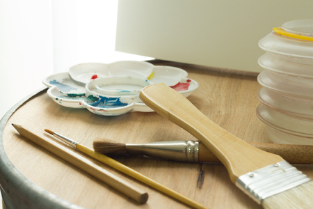 painting equipment on wooden background with light curtainの写真素材