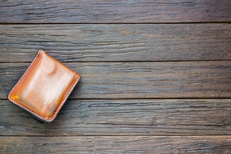 brown wallet on wooden backgroundの写真素材