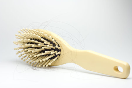 combs with hair on white background