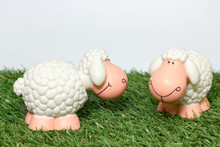 sheep toy on artificial grassの写真素材