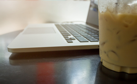 technology, business and modern life concept close up of open laptop computer on table near window with bright sunshineの写真素材
