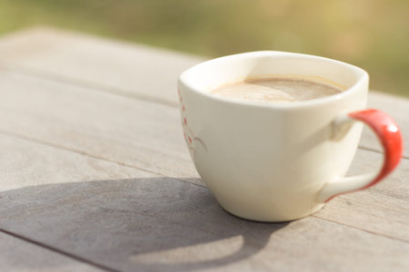 coffee cup on wooden table in morningの写真素材