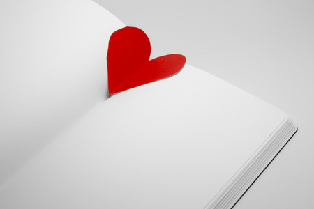 diary with paper heart on white backgroundの写真素材