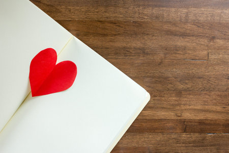 diary and  red heart on wooden backgroundの写真素材