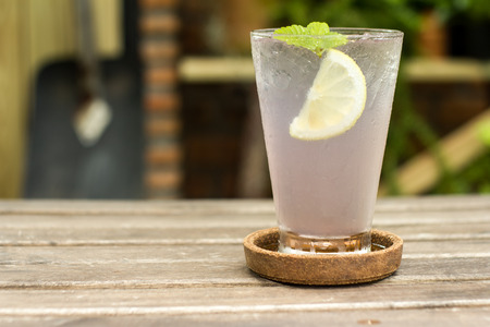 lavender lemon juice with ice on wooden tableの写真素材