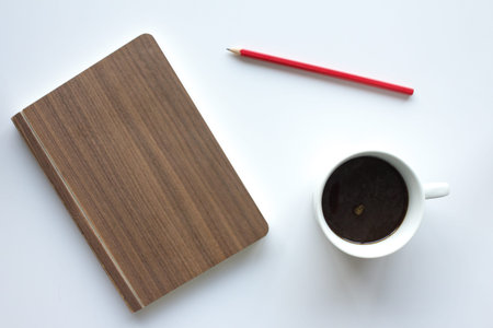 coffee cup, notepad and pencil  on white background