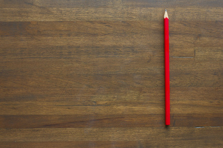 red pencil on wooden backgroundの写真素材
