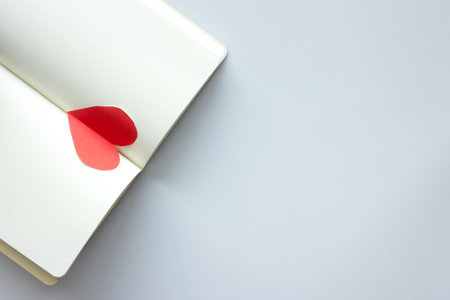 diary and  red heart on white backgroundの写真素材