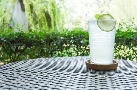 fresh lime cocktail with soda on a wooden background.の写真素材
