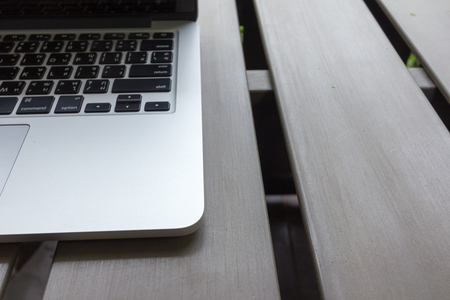 laptop on wooden desk in workplaceの写真素材