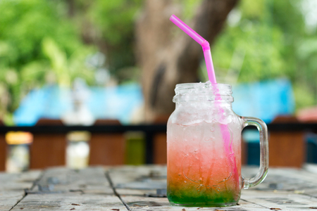 italian soda with ice on wooden tableの写真素材