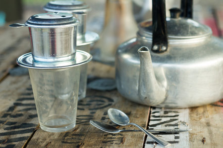 Coffee brewed in traditional vietnamese style on wooden tableの写真素材