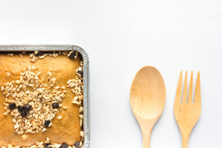 almond cake square shape with cutlery on white cloth background texture take photo close up top viewの写真素材