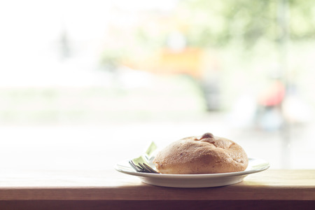 bread on wooden table with window lightの写真素材