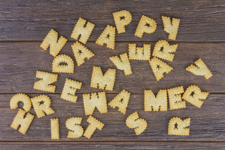 biscuit letters on wooden background, vintage color toneの写真素材
