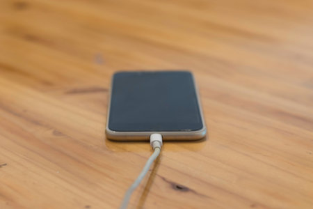 smartphone is charge on wooden  tableの写真素材