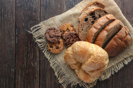 top view of bread with napery on wooden table