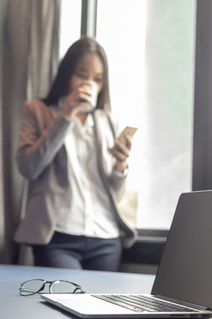 smart Asian business female relax with coffee after workingの写真素材
