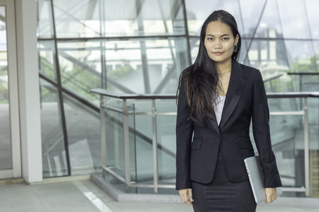 successful asian business female with laptop computer at office buildingの写真素材