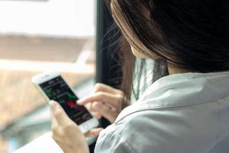Close-up of female using smart phone with reading some messageの写真素材