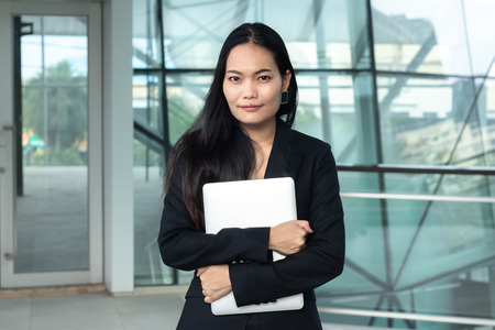 asian business female with laptop computer at office buildingの写真素材