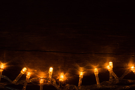 Electric lighted garland on wooden backgroundの写真素材