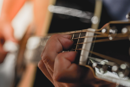 Acoustic Guitar Playing. Men Playing Acoustic Guitar Closeup Photography.	の写真素材