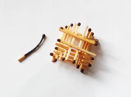 building matchsticks and burnout one on white paperの写真素材