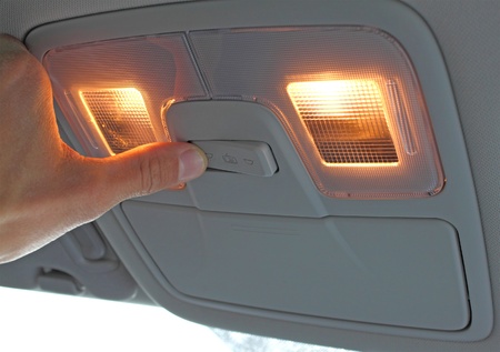 turn on light switch in the car, with handの写真素材