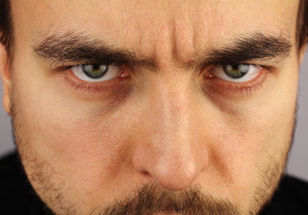 portrait of a man, menacing look, closeup, studioの写真素材