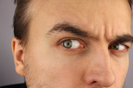 portrait of a man, distrustful look, closeup, studioの写真素材