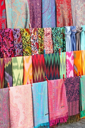a lot of handmade fabric of different colors on showcase, at marketplace in Uzbekistanの写真素材