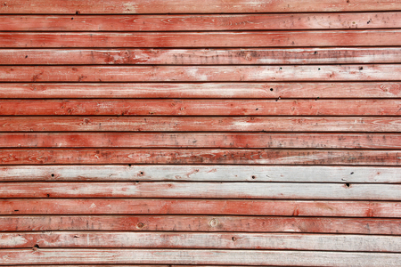 many of horizontal horizontal wooden planks with peeling red paint, textureの写真素材