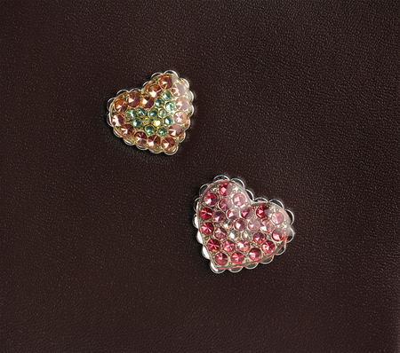 two hearts with gems on the brown leatherの写真素材