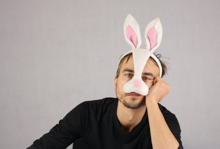 man in the mask Easter rabbit and black underwear looking at camera, studio