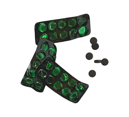 three empty green pill boxes and six black pills, isolated, top viewの写真素材