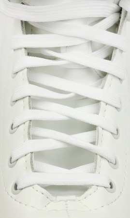 neatly laced white leather skates boot, white textile laces, close-upの写真素材