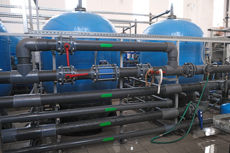 many water pipes and tanks with valves and faucets,  wastewater treatment facilities indoors,...