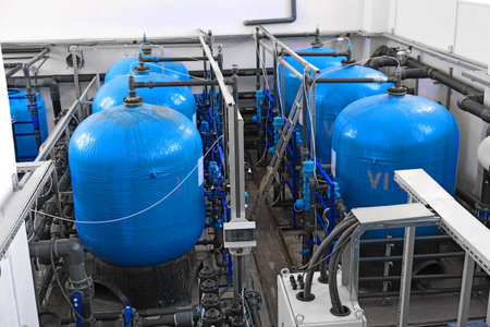 many big blue water tanks inside wastewater treatment facility, industrial interior inside, water...