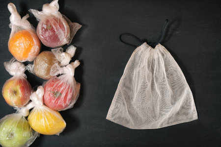 Colored fruits in the plastic package on blackの写真素材