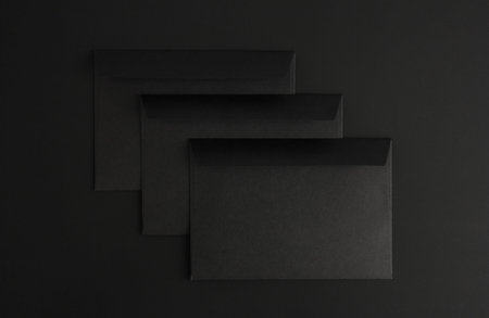 three blank black envelopes on black background, letter mockup with copy space, total black