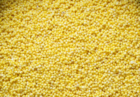 washed millet groats, ingredient for making a gluten-free vegan or vegetarian dish, top view close up, cooking at homeの写真素材