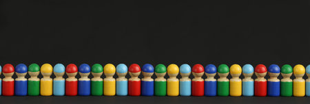 colorful wooden toy people are lined up in a row, black background with copy space, concept of multinational community or a queue at the storeの写真素材