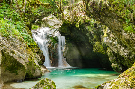 Natural long-exposure twin waterfall on Soca river in Slovenia. Velika Korita Soceの写真素材