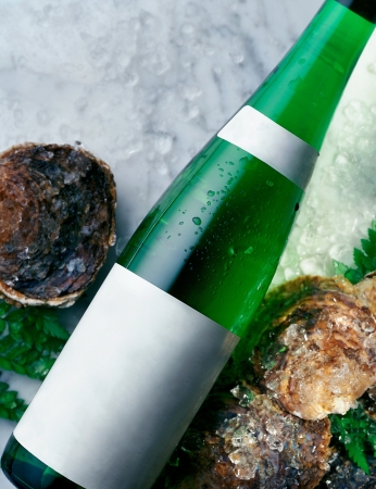 Closeup Shot of a Bottle of White Wine and Fresh Oystersの写真素材