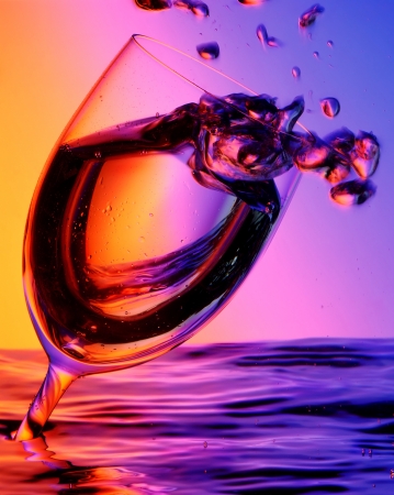 Cup of water with bubbles in a colourful backgroundの写真素材
