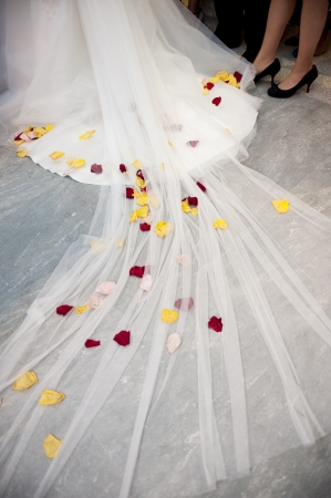 Red and Yellow Flowers in a White Wedding Dressの写真素材