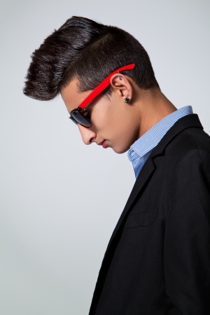 Trendy Teenager with Hair Crest in a Grey Backgroundの写真素材